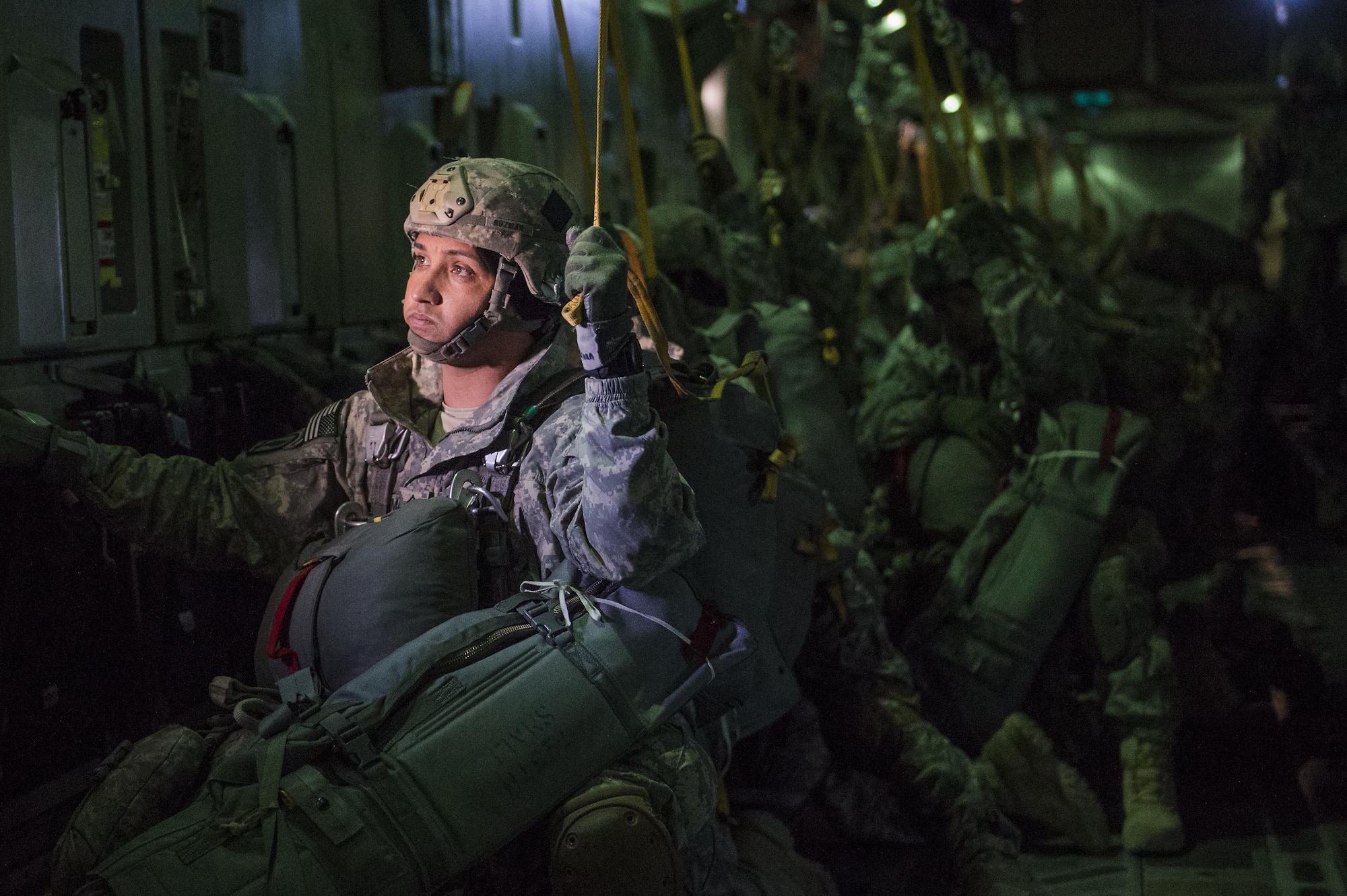 U.S. Army 1st Sgt. Shalim Guzman, assigned to the 4th Infantry Brigade Combat Team (Airborne), 25th Infantry Division, prepares to jump out of a C-17 Globemaster III during a formation flight from Joint Base Elmendorf-Richardson, Oct. 19, 2016. 