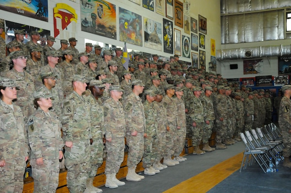Soldiers assigned to the 17th Sustainment Brigade and the 369th Sustainment Brigade, 1st Sustainment Command (Theater), sing The Army Goes Rolling Along during a transfer of authority ceremony October 26, 2016, at Camp Arifjan, Kuwait. The 369SB relieved the 17SB after its nine-month deployment to the Middle East. (Army National Guard photo by Sgt. Walter H. Lowell)