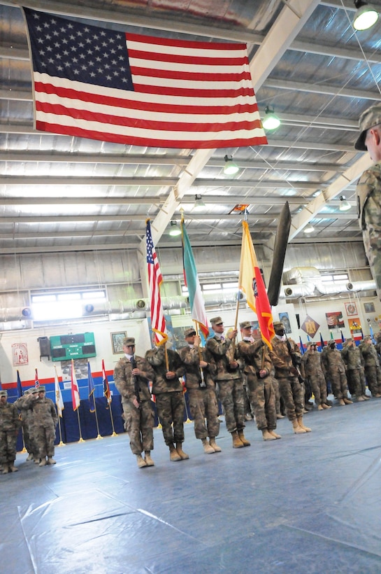 A color guard composed of Soldiers assigned to the 17th Sustainment Brigade and the 369th Sustainment Brigade, 1st Sustainment Command (Theater), present the colors for the playing of the Kuwaiti and American national anthems during a transfer of authority ceremony October 26, 2016, at Camp Arifjan, Kuwait. As the first National Guard unit to complete this mission, the 17SB transferred authority to the 369SB, a National Guard unit from New York. (Army National Guard photo by Sgt. Walter H. Lowell)