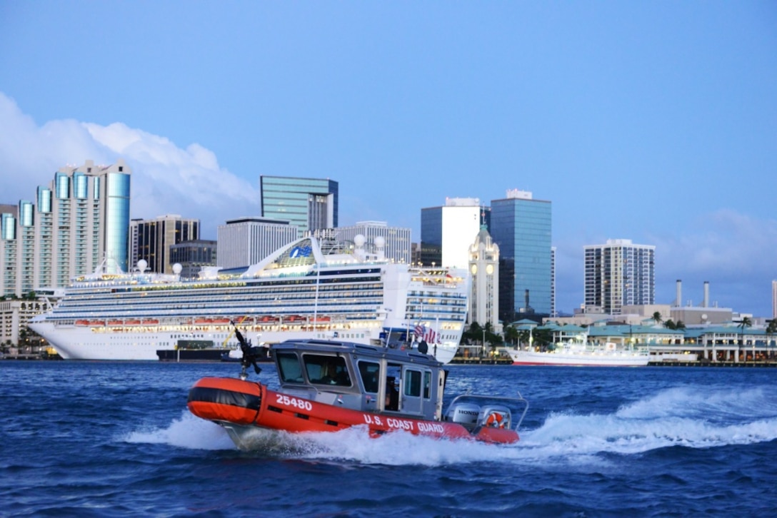 Crew members aboard a 25-foot Response Boat-Small from Maritime Safety and Security Team 91107 escort the cruise ship Pride of America out of Honolulu Harbor. The Coast Guard conducts escorts of high-capacity passenger vessels to ensure security of the passengers, the vessel and the port. (U.S. Coast Guard photo by Petty Officer 3rd Class Melissa E. McKenzie)