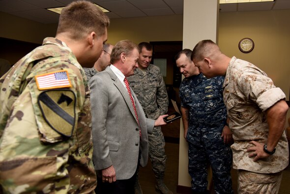 Theodore “Tip” Hargrove, 316th Training Squadron honorary commander, shows U.S. Air Force Col. Jeffery Sorrell, 17th Training Wing Vice Commander, Col. Christopher Harris, 17th Mission Support Group Commander, U.S. Army Maj. Corey Gamble, 344th Military Intelligence Battalion executive officer, U.S. Navy Lt. Cmdr. Christopher Allen, Navy Center for Information Welfare Training Detachment Goodfellow, and U.S. Marine Corps Maj. Andrew Armstrong, Marine Corps Detachment Commanding Officer, retired Col. Richard Cole’s Congressional Gold Medal at the Norma Brown building on Goodfellow Air Force Base, Texas, Oct. 25, 2016. Cole received the medal for his part in the Doolittle Raids and is donating it to the Citadel, South Carolina, to keep the history of the event alive. (U.S. Air Force photo by Senior Airman Joshua Edwards/Released)