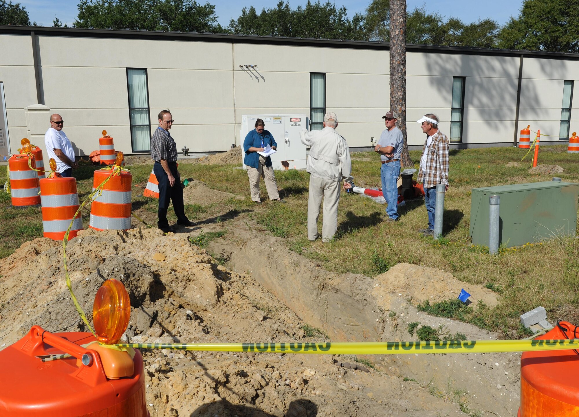 Base Operations Support members and contractors survey the grounds at the McBride Commons Oct. 24, 2016, on Keesler Air Force Base, Miss. The renovation project will transition the former base library into a common area housing children’s library, computer stations, engraving, framing, marketing and print shops and a full kitchen. The nine-month project is expected to be completed by May 2017. (U.S. Air Force photo by Kemberly Groue/Released) 