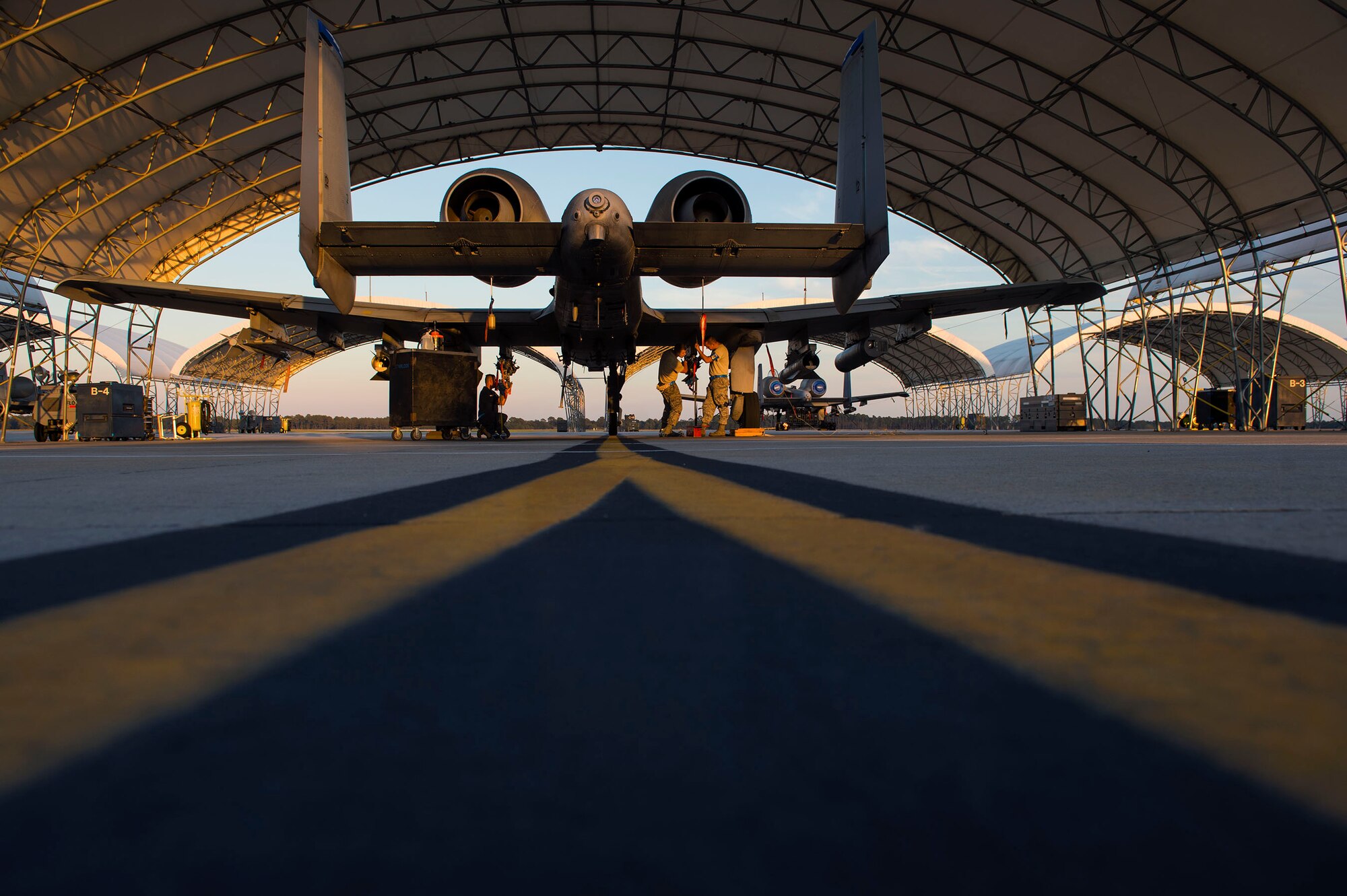 Aircraft armament systems technicians from the 23d Aircraft Maintenance Squadron equip an A-10C Thunderbolt II before night operational flight training, Oct. 25, 2016, at Moody Air Force Base, Ga. The training consisted of 74th Fighter Squadron pilots maintaining aviation proficiency and practicing accurately delivering inert weapons to enhance their close-air support mission. (U.S. Air Force photo by Airman 1st Class Greg Nash)