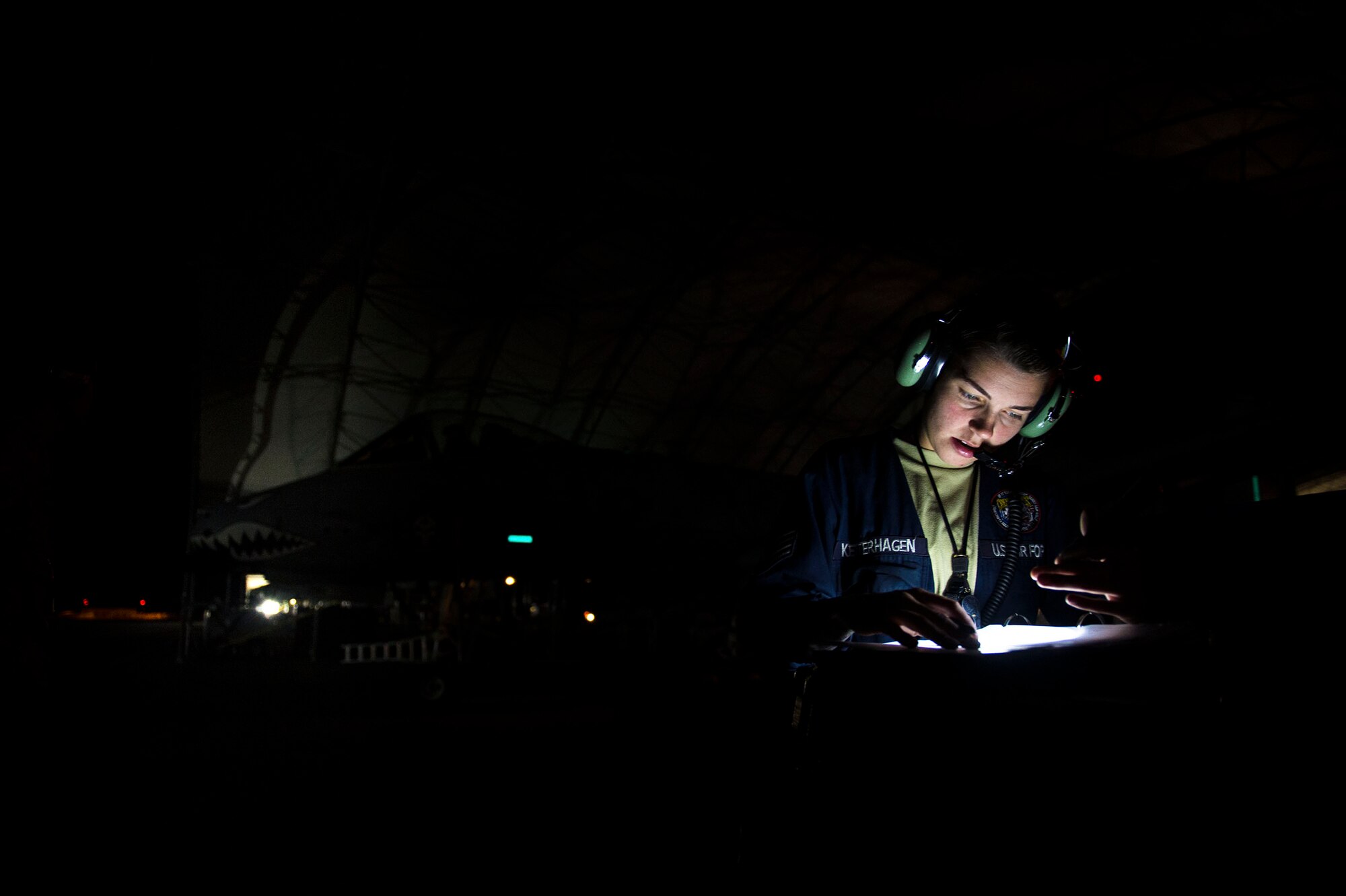 Staff Sgt. Alexandria Ketterhagen, 74th Aircraft Maintenance Unit dedicated crew chief, checks the technical order for maintenance actions on an A-10C Thunderbolt II, prior to night operational flight training, Oct. 25, 2016, at Moody Air Force Base, Ga. Ketterhagen communicated with Capt. Roberto Manzo, 74th Fighter Squadron A-10C Thunderbolt II pilot, to diagnose and ensure there aren’t any maintenance problems before flight. (U.S. Air Force photo by Airman 1st Class Greg Nash)