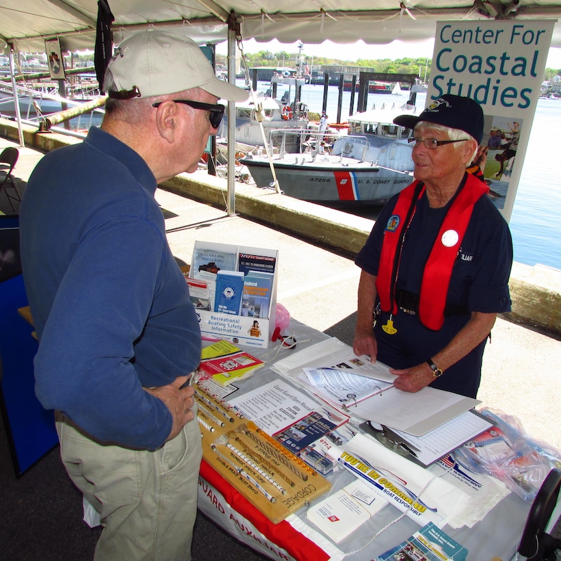 An Auxiliarist answers vessel safety 
questions during the Safe Boating Day Open House at Coast Guard 
Station Gloucester, Massachusetts. The annual event 
draws hundreds of visitors interested in recreational boating safety. 
May 21 – 27 is National Safe Boating Week and the launch of the Annual North American Safe Boating Campaign, a yearlong effort focused on spreading the message of boating safety and the critical importance of always wearing a life jacket each and every time on the water. (U.S. Coast Guard Auxiliary photo by: John W. Keyes)