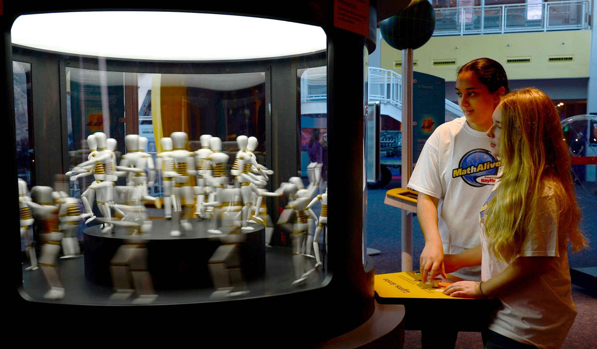 Ayat Yousef and Chyann Gross, Kecoughtan High School students, learn about rotational frequency at the MathAlive! exhibit at the Virginia Air and Space Center in Hampton, Va., Oct. 20, 2016. The traveling exhibit provides visitors with 40 different interactive activities geared toward science, technology, engineering and mathematics, or STEM, with video games, sports, and design. (U.S. Air Force photo by Airman 1st Class Kaylee Dubois)