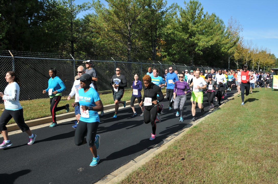 Near the start of the course, Beofra Butler of DLA (left foreground, in blue cap) begins her run to be the first-place female runner at the 2016 Monster Dash.