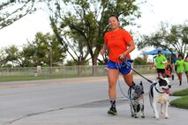 Capt. Brooke Organ, 47th Medical Operations Squadron flight surgeon, runs with her dogs Leo and Honcho during Laughlin’s Wingman Challenge on Laughlin Air Force Base, Texas, Oct. 15, 2016. While Organ’s official wingman, Staff Sgt. Shon Nguyen, 47th Medical Operations Squadron Family Health flight chief, was running on two legs, four-legged Leo and Honcho were still part of the team.  (U.S. Air Force photo/Airman 1st Class Benjamin N. Valmoja)