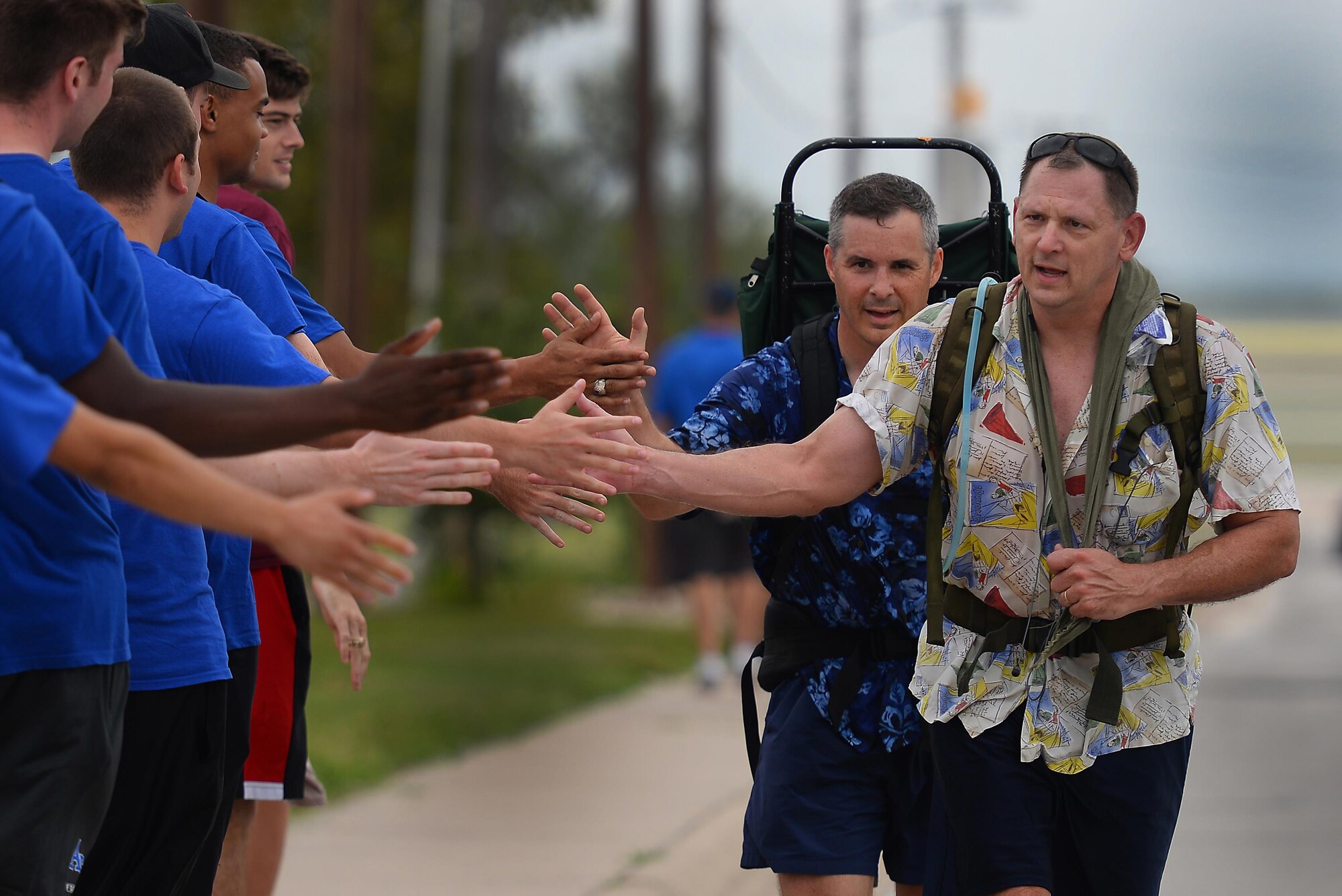 Col. Brian Hinsvark, 47th Mission Support Group commander (right) and Col. Thatcher Cardon, 47th Medical Group commander (center), pass on encouragement to bystanders at Laughlin’s Wingman Challenge on Laughlin Air Force Base, Texas, Oct. 15, 2016. Hinsvark and Cardon completed the entire 5k run, with the additional 5k ruck march that included various exercises.  (U.S. Air Force photo/Airman 1st Class Benjamin N. Valmoja)