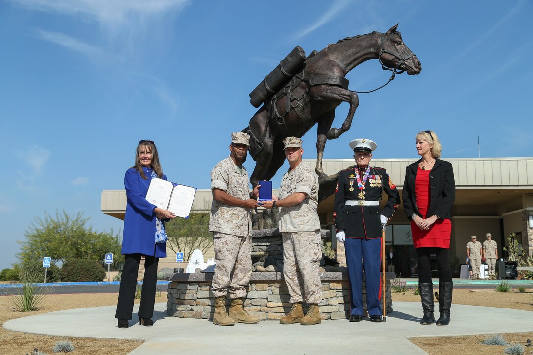 U.S. Marine Corps Brig. Gen. Kevin J. Killea, commanding general, Marine Corps Installations West, Marine Corps Base, Camp Pendleton, center right, and Lt. Col. Rafael Candelario, executive officer, 5th Marine Regiment, I Marine Expeditionary Force, center left, pose for a photo with the contributors to the Staff Sgt. Reckless monument on Camp Pendleton, Calif., Oct. 26, 2016. War horse, Staff Sgt. Reckless, was known for her heroics at the Battle of Outpost Vegas during the Korean War and received many military decorations. (U.S. Marine Corps photo by Lance Cpl. Brooke Woods)