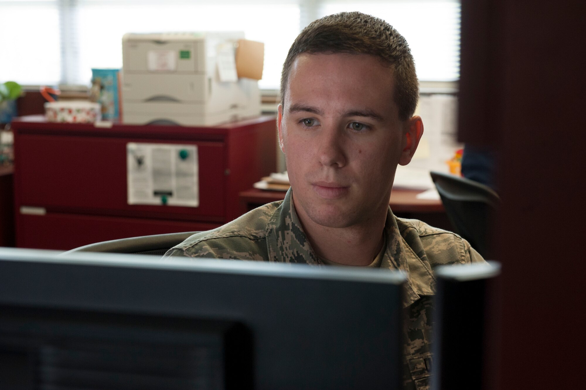 U.S. Air Force Senior Airman Jens Kaiser, 18th Comptroller Squadron budget analyst, works on Temporary Duty orders Oct. 25, 2016, at Kadena Air Base, Japan. Budget analysts often help prepare TDY orders, determining proper funding for the mission. (U.S. Air Force photo by Senior Airman Lynette M. Rolen/Released)