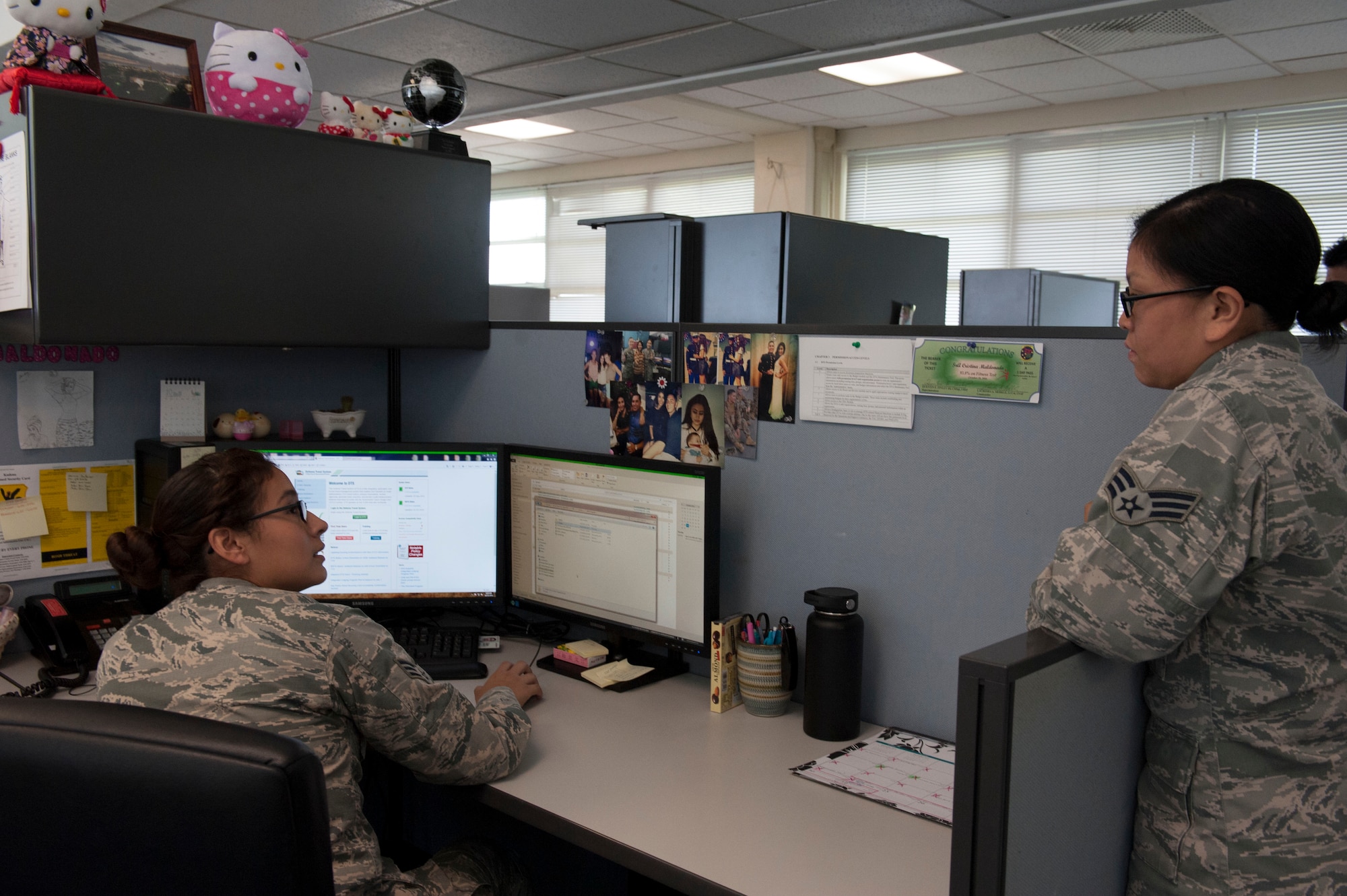 U.S. Air Force Senior Airman Cristina Maldonado, 18th Comptroller Squadron Defense Travel System team lead, assists Senior Airman Manna Branson, 18th CPTS travel accounting technician, with a request concerning DTS Oct. 25, 2016, at Kadena Air Base, Japan. DTS manages any government-related travel authorizations, including such items as reservations, travel vouchers and government travel cards. (U.S. Air Force photo by Senior Airman Lynette M. Rolen/Released)