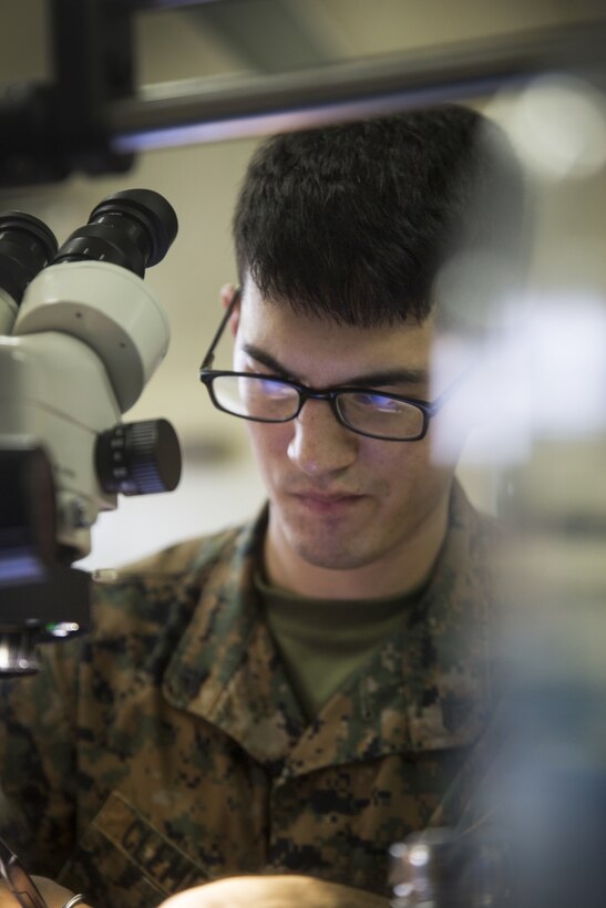 Cpl. Ricki D. Clement works diligently on a new repair with a puzzled look Oct. 20, 2016 at Camp Kinser, Okinawa, Japan. Most of Clement’s workspace is brand new with new equipment he has been compensating for with only a handful of tools. Clement’s innovational talent has saved the Marine Corps thousands of dollars in logistics and maintenance. Clement, from Houston, Texas, is a micro/miniature repair man with Electronics Maintenance Company, 3rd Maintenance Battalion, Combat Logistics Regiment 35, 3rd Marine Logistics Group, III Marine Expeditionary Force. (U.S. Marine Corps photo by Lance Cpl. Breanna Weisenberger/ Released)
