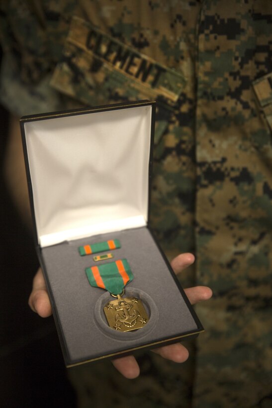 U.S. Marine Corps Cpl. Ricki D. Clement, a micro/miniature repair man with Electronics Maintenance Company, 3rd Maintenance Battalion, III Marine Expeditionary Force, displays his Navy and Marine Corps Achievement medal he received for exceptional innovation at Camp Kinser, Okinawa, Japan, Oct. 20, 2016. Clement repaired a radio tester unit using a Vehicular Amplifier Unit, saving the Marine Corps nearly $64,000 in logistics and maintenance. (U.S. Marine Corps photo by Lance Cpl. Breanna Weisenberger) 