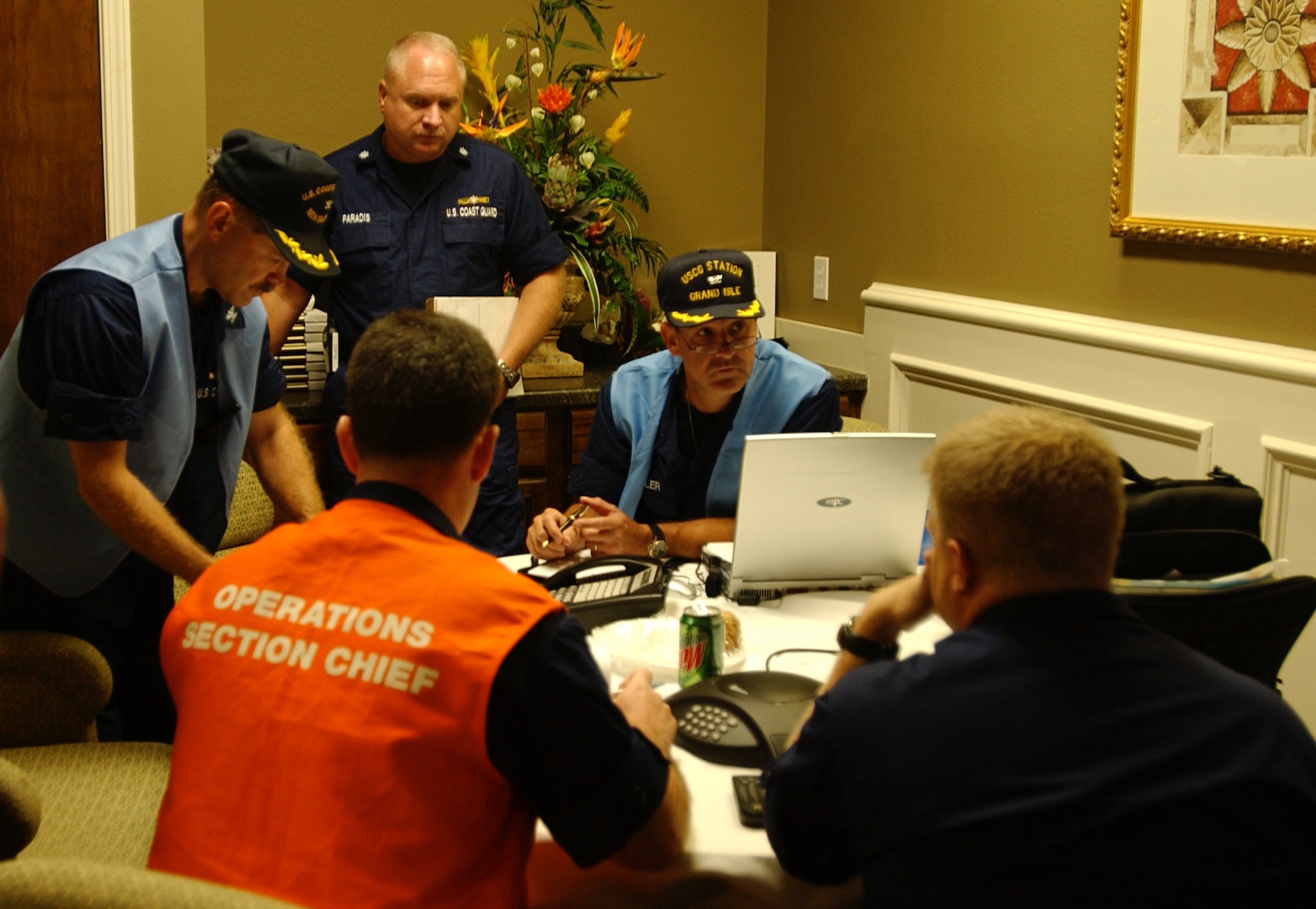 Coast Guard incident leaders discuss response plans at the incident command center. Coast Guard personnel are gathering information and initial damage reports from agency partners concerning Hurricane Katrina.  (U.S Coast Guard Photo by Petty Officer 3rd Class Robert Reed)