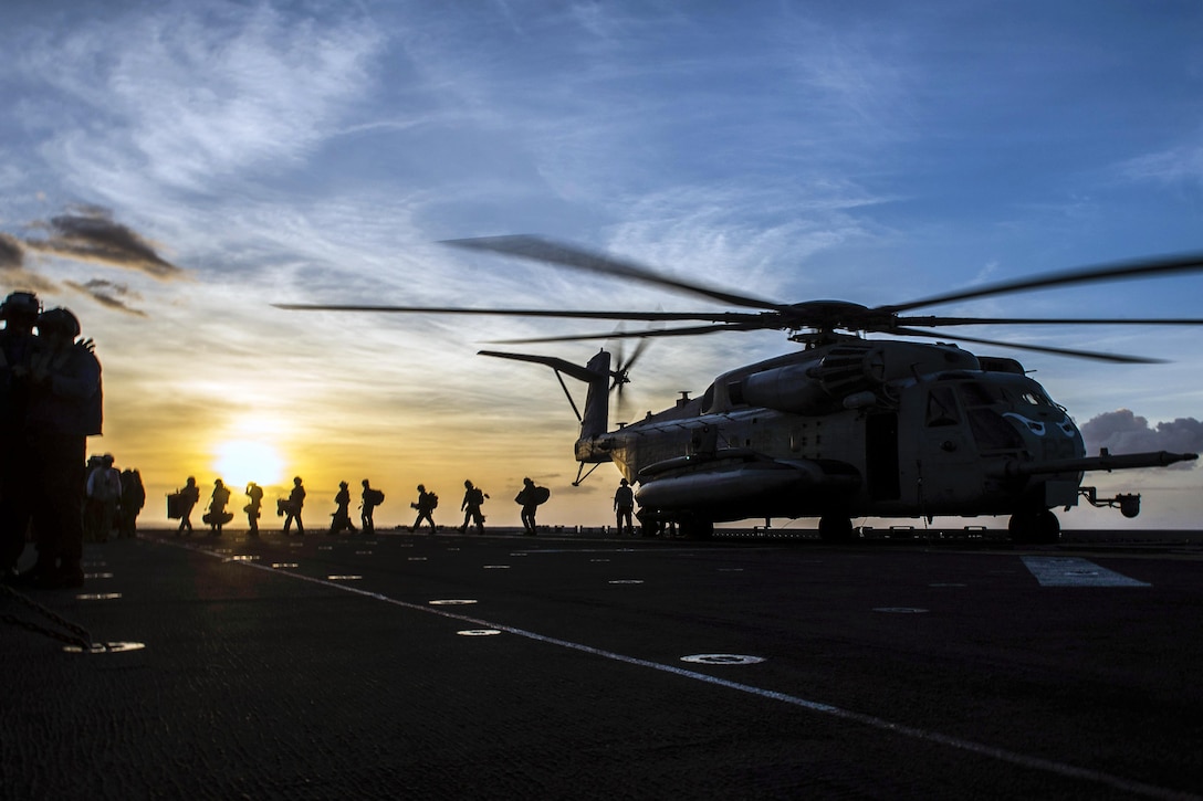 Marines depart a CH-53E Super Stallion aboard the USS Makin Island in the Pacific Ocean, Oct. 22, 2016. The amphibious assault ship is supporting the Navy’s maritime strategy in the U.S. 3rd Fleet area of responsibility. The helicopter is assigned to Marine Medium Tiltrotor Squadron 163. Navy photo by Seaman Devin M. Langer
