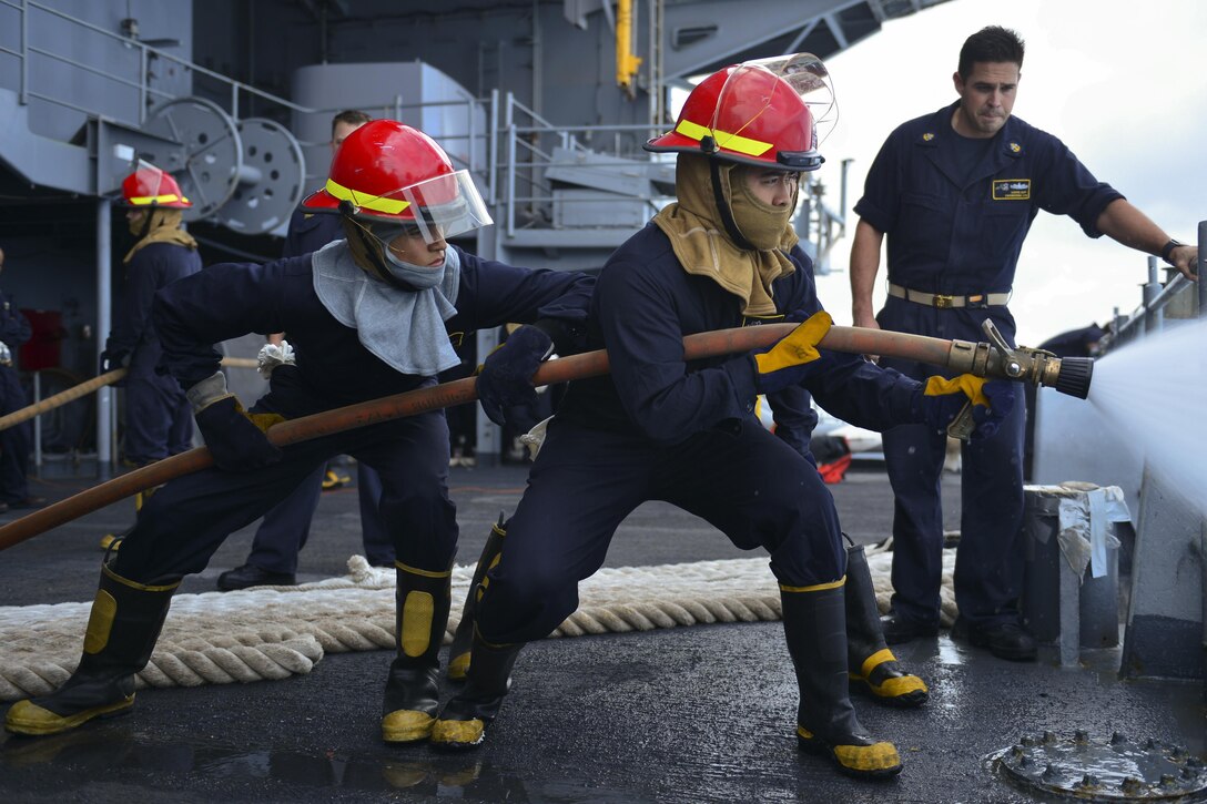 Sailors practice firefighting during a damage control training drill on the USS Nimitz in the Pacific Ocean, Oct. 25, 2016. The Nimitz is preparing for deployment in 2017. Navy photo by Seaman Trenton J. Kotlarz