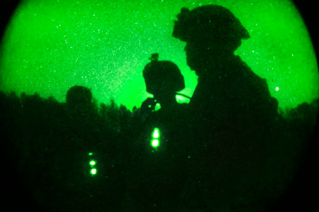 As seen through a night-vision device, Marines participate in a helicopter support training exercise on Phoenix landing zone at Camp Lejeune, N.C., Oct. 20, 2016. Marine Corps photo by Lance Cpl. Jack A. E. Rigsby