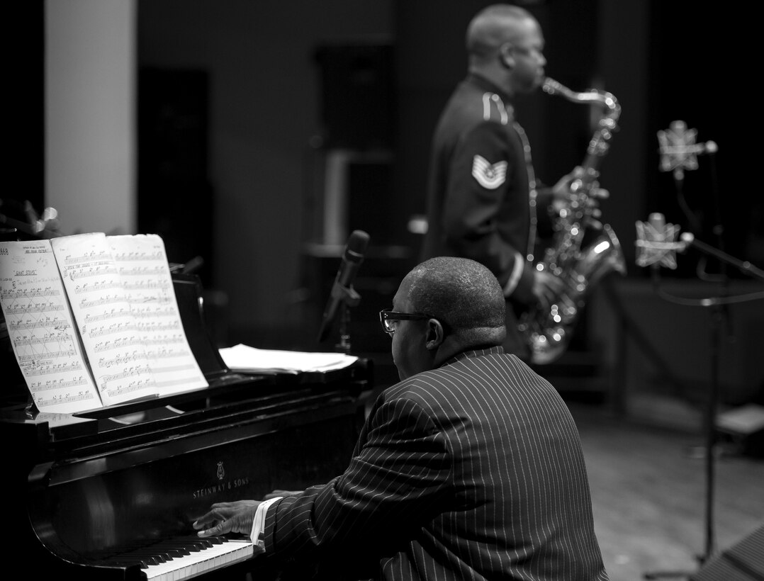 Cyrus Chestnut, jazz pianist, plays the piano alongside Tech. Sgt. Grant Langford, U.S. Air Force Band's Airmen of Note tenor saxophonist, during the 2016 Jazz Heritage Series performance at the Rachel M. Schlesinger Concert Hall in Alexandria, Va., Oct. 21, 2016. Chestnut, who has worked with many big bands, including the Lincoln Center Jazz Orchestra and the Dizzy Gillespie All-Star Big Band, was the featured guest during this series performance. The Airmen of Note established the Jazz Heritage Series in 1990 and each year they perform with legendary icons of jazz. (U.S. Air Force photo by Airman Gabrielle Spalding)