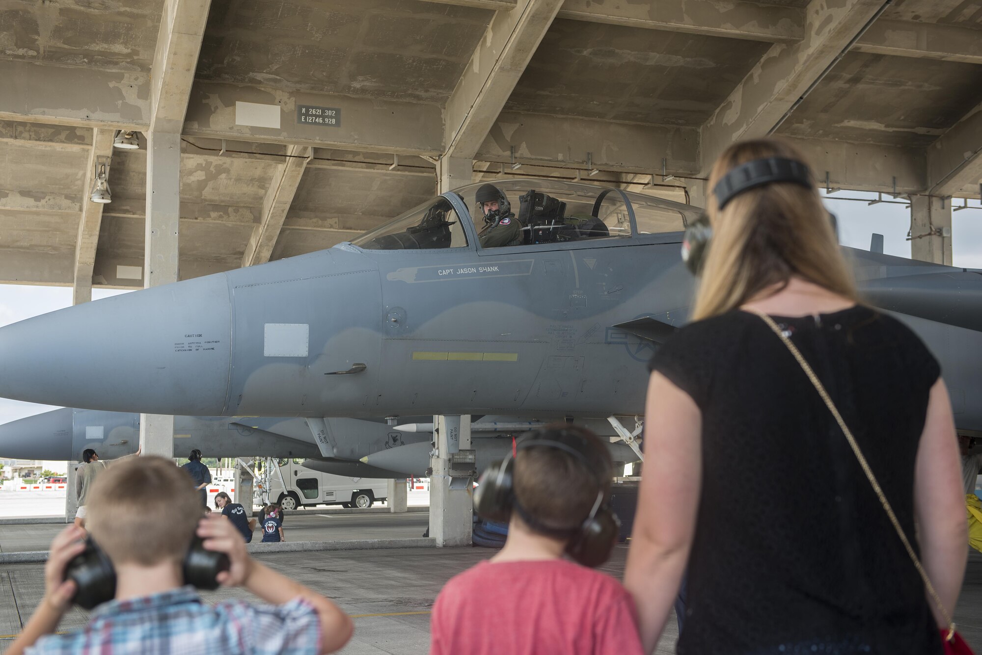 U.S. Air Force Capt. Tyson Hyer, 44th Fighter Squadron pilot, parks an F-15 Eagle as his family waits for him Oct. 26, 2016, at Kadena Air Base, Japan. The 44th FS returned from training in exercises around the Indo-Asia Pacific region. (U.S. Air Force photo by Airman 1st Class Corey M. Pettis/Released)