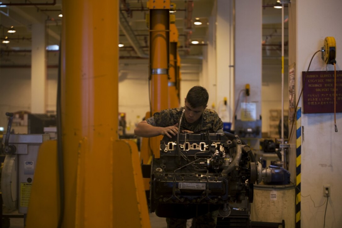 Cpl. Matthew A. Long turns a wrench on a High Mobility Multipurpose Wheeled Vehicle (HMMWV) engine on Camp Kinser, Okinawa, Japan, October 25, 2016. Long was selected as a winner in a Marine Corps logistical innovation competition for incorporating a blood clotting agent and pain killer with a Small Arms Protective Insert (SAPI) to minimize the time between injury and aid. Long, from Moultrie, Georgia, is a motor transport mechanic with Motor Transport Company, Maintenance Battalion, Combat Logistics Regiment 35, 3rd Marine Logistics Group, III Marine Expeditionary Force. (U.S. Marine Corps photo by Lance Cpl. Nelson Duenas/ Released)