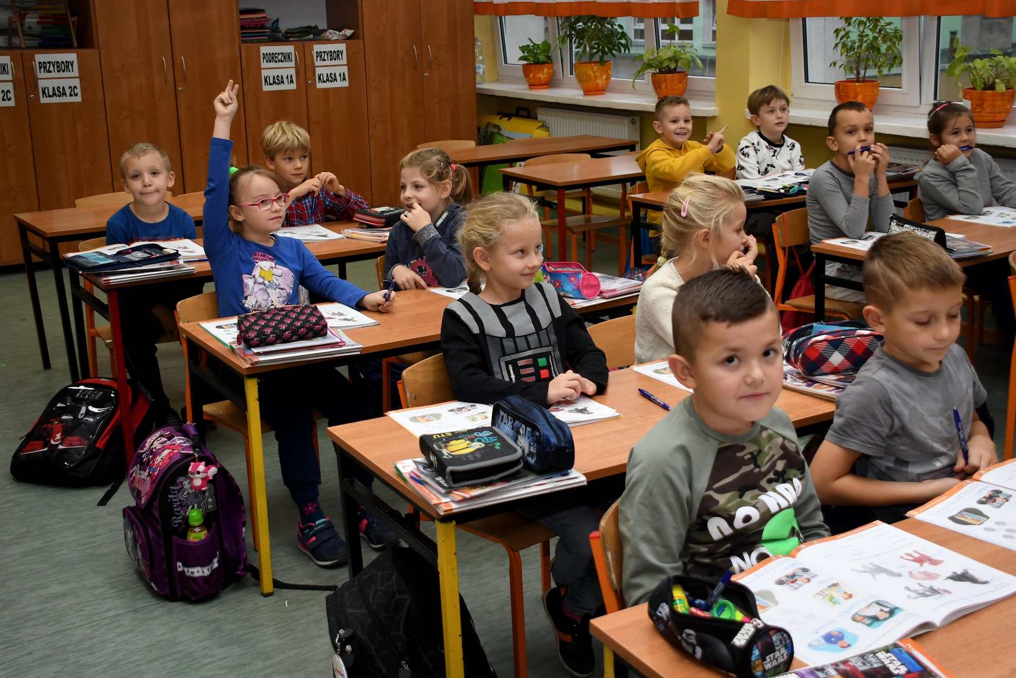 Students at Elementary School No. Nine in Gniezno, Poland, participate in a classroom discussion with members of the 94th Airlift Wing, Dobbins Air Reserve Base, Georgia, and the 86th Airlift Wing, Ramstein Air Base, Germany, Oct. 19, 2016. The Airmen made a cultural orientation visit to the school while the two units are working with the Polish air force during Aviation Detachment 17-1 in support of Operation Atlantic Resolve. (U.S. Air Force photo by Staff Sgt. Alan Abernethy)