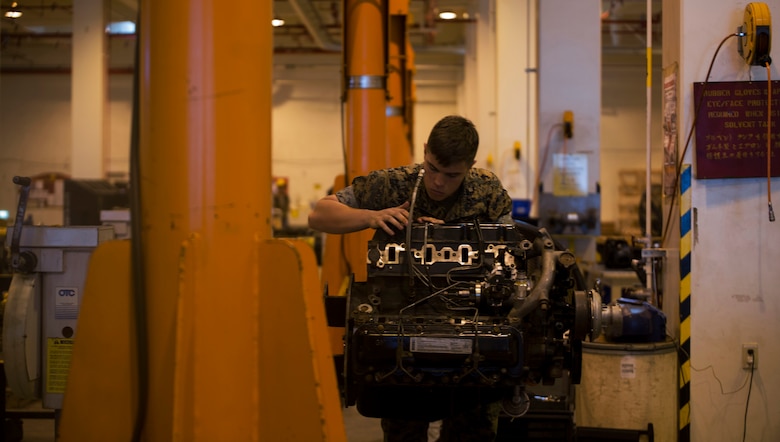 Cpl. Matthew A. Long turns a wrench on a High Mobility Multipurpose Wheeled Vehicle engine on Camp Kinser, Okinawa, Japan, October 25, 2016. Long was selected as a winner in a Marine Corps logistical innovation competition for incorporating a blood clotting agent and pain killer with a Small Arms Protective Insert to minimize the time between injury and aid. Long, from Moultrie, Georgia, is a motor transport mechanic with Motor Transport Company, Maintenance Battalion, Combat Logistics Regiment 35, 3rd Marine Logistics Group, III Marine Expeditionary Force. 