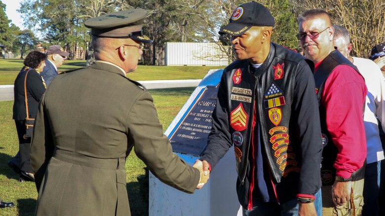 Col. Steven Wolf, commanding officer of the School of Infantry – East, shakes hands with Kevin Jiggetts, a former Marine with 1st Battalion 8th Marines, at the Beirut Wreath Laying Ceremony at Camp Geiger on Marine Corps Air Station New River Oct. 23, 2016. The ceremony is one of three memorial ceremonies conducted in the Marine Corps Base Camp Lejeune area every year to memorialize the Beirut Bombing with Marines from 1st Battalion 8th Marines.