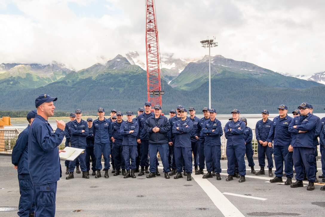 The Commander of the Cutter Healy addresses the crew during quarters on the flight deck in Seward,
Alaska. Preparing for its second mission, the Cutter Healy embarked a team of
researchers from the Scripps Institution of Oceanography, UC-San Diego, and
the Office of Naval Research who are deploying an array of acoustic bottom
moorings to collect data on how climate change and decreased ice coverage is
affecting the Arctic Ocean. (U.S. Coast Guard photo by Petty Officer 2nd
Class Christopher M. Yaw/Pacific Area External Affairs)