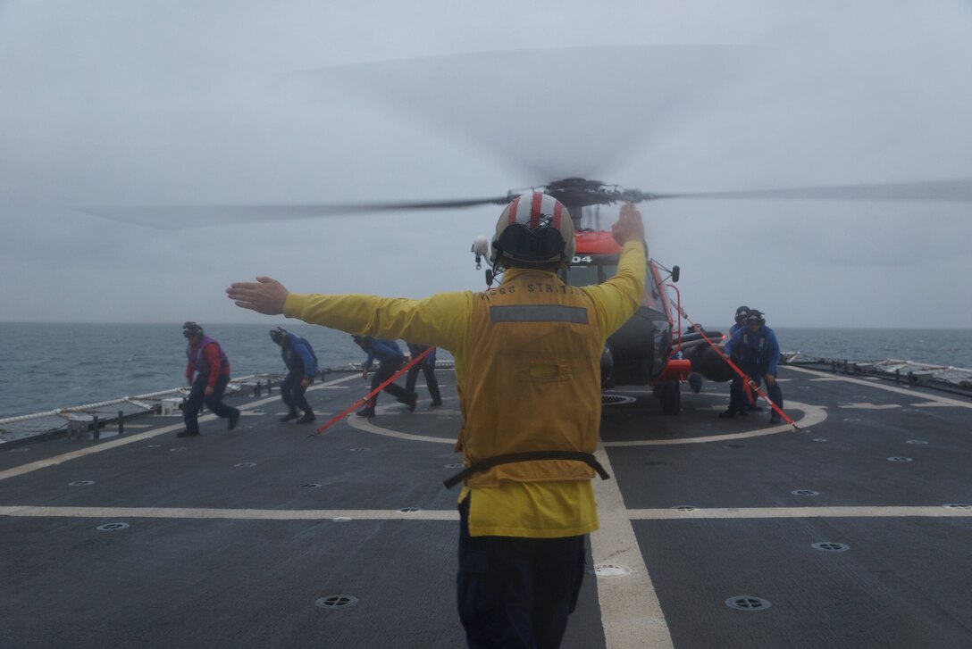 A Coast Guard Ensign signals the crew of a Coast Guard helicopter during a training
exercise on the U.S. Coast Guard Cutter Stratton as part of Operation Arctic
Shield 2016. As part of Arctic Shield 2016, the Coast Guard will deploy
cutters, aircraft, and personnel to the region to engage in operations
encompassing a variety of Coast Guard missions across the North Slope. (U.S.
Coast Guard photo by Lt.j.g. Gina Caylor)
