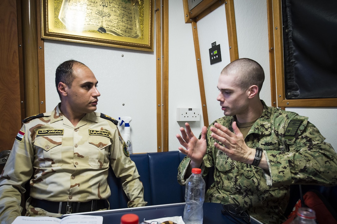 A U.S. Coast Guard Lt., assigned to Patrol Forces Southwest Asia
(PATFORSWA), talks with commanding officer of the Iraqi Navy Swift Ship (P 302),
before a Maritime Infrastructure Protection Exercise (MIPEX) between U.S.
and Iraqi Navies, and U.S. Coast Guard. (U.S. Navy photo by Mass Communication
Specialist 1st Class Benjamin A. Lewis/Released)