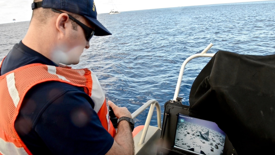 A 1st Class Petty Officer , a diver with Regional Dive Locker Pacific, locates
a ray with a remotely operated vehicle off Honolulu. The crews culminated
several days of training with the remotely operated vehicle by deploying it
in the ocean near Oahu. (U.S. Coast Guard photo by Chief Petty Officer Sara
Mooers)