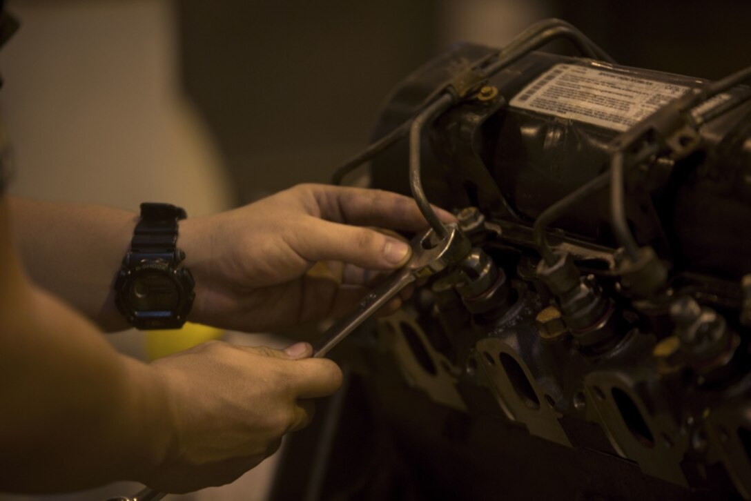 Cpl. Matthew A. Long turns a wrench on a High Mobility Multipurpose Wheeled Vehicle (HMMWV) engine on Camp Kinser, Okinawa, Japan, October 25, 2016. Long was selected as a winner in a Marine Corps logistical innovation competition for incorporating a blood clotting agent and pain killer with a Small Arms Protective Insert (SAPI) to minimize the time between injury and aid. Long, from Moultrie, Georgia, is a motor transport mechanic with Motor Transport Company, Maintenance Battalion, Combat Logistics Regiment 35, 3rd Marine Logistics Group, III Marine Expeditionary Force. (U.S. Marine Corps photo by Lance Cpl. Nelson Duenas/ Released)
