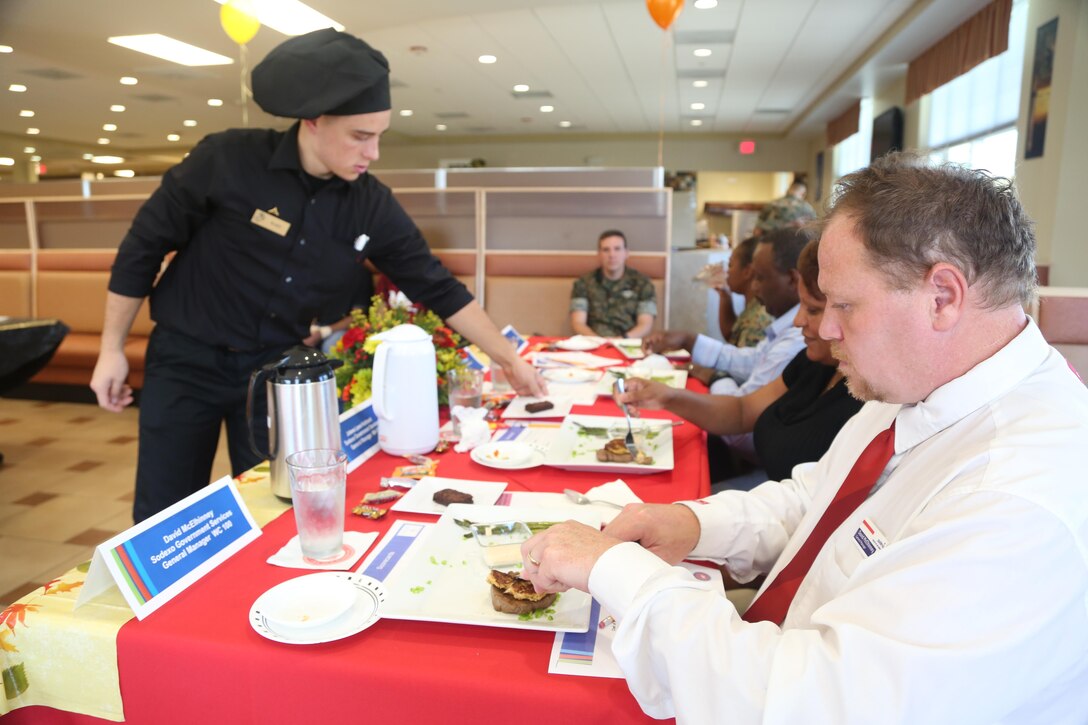 David McElhinney, Wallace Creek mess hall general manager, prepares to taste a dish prepared by Marine cooks during the Chef of the Quarter competition at the Wallace Creek Mess Hall, Oct. 20. During the bi-annual event, four teams from various mess halls vied for the Chef of the Quarter Award and People’s Choice Award. (U.S. Marine Corps photo by Cpl. Mark Watola /Released)