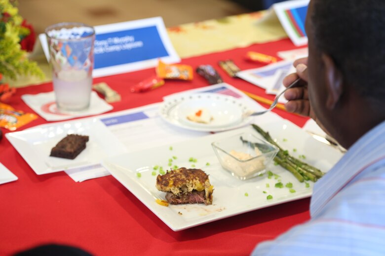 Tony Murphy, a Chef of the Quarter competition judge, prepares to taste a dish prepared by Marine cooks during the event at the Wallace Creek Mess Hall, Oct. 20. During the bi-annual event, four teams from various mess halls vied for the Chef of the Quarter Award and People’s Choice Award. (U.S. Marine Corps photo by Cpl. Mark Watola /Released)