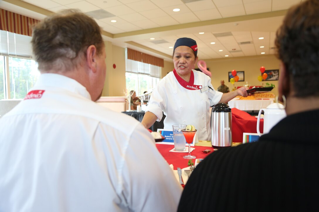 Violeta Smith, Courthouse Bay mess hall chef, presents her dish during the Chef of the Quarter competition at the Wallace Creek Mess Hall, Oct. 20. During the bi-annual event, four teams from various mess halls vied for the Chef of the Quarter Award and People’s Choice Award. (U.S. Marine Corps photo by Cpl. Mark Watola /Released)