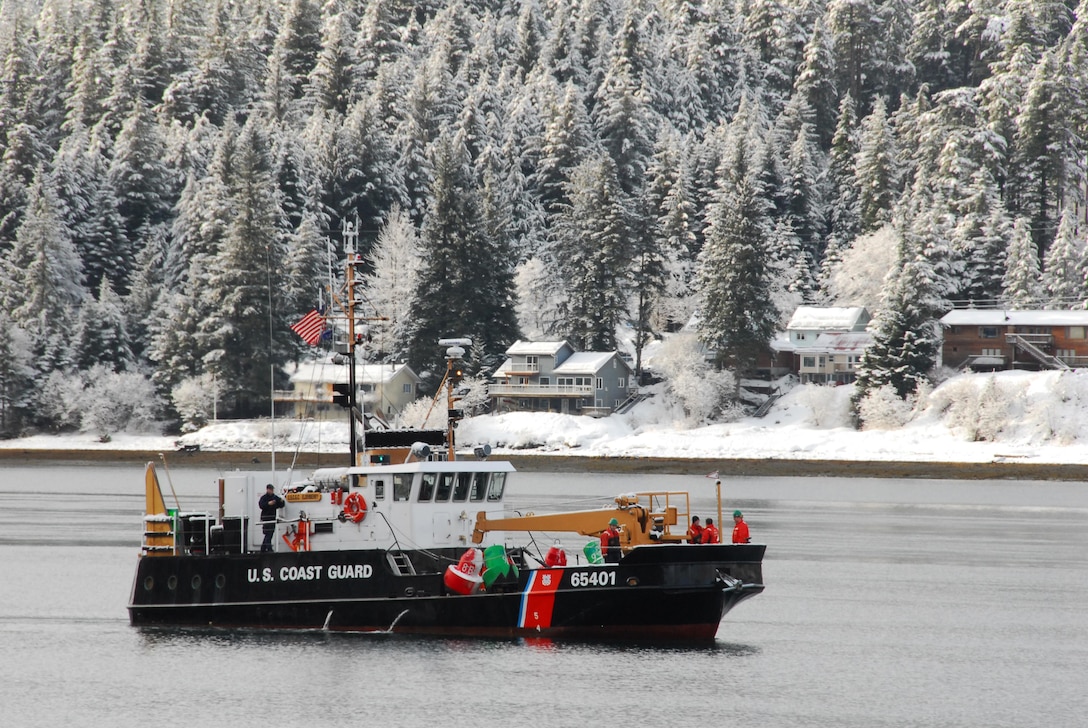 Crew members aboard the Coast Guard Cutter Elderberry, a 100-foot inland buoy tender homeported in Petersburg, Alaska, prepare buoys to be set in the channel which runs through Mendenhall Bar. (U.S. Coast Guard Photo by Petty Officer 3rd Class Walter Shinn)