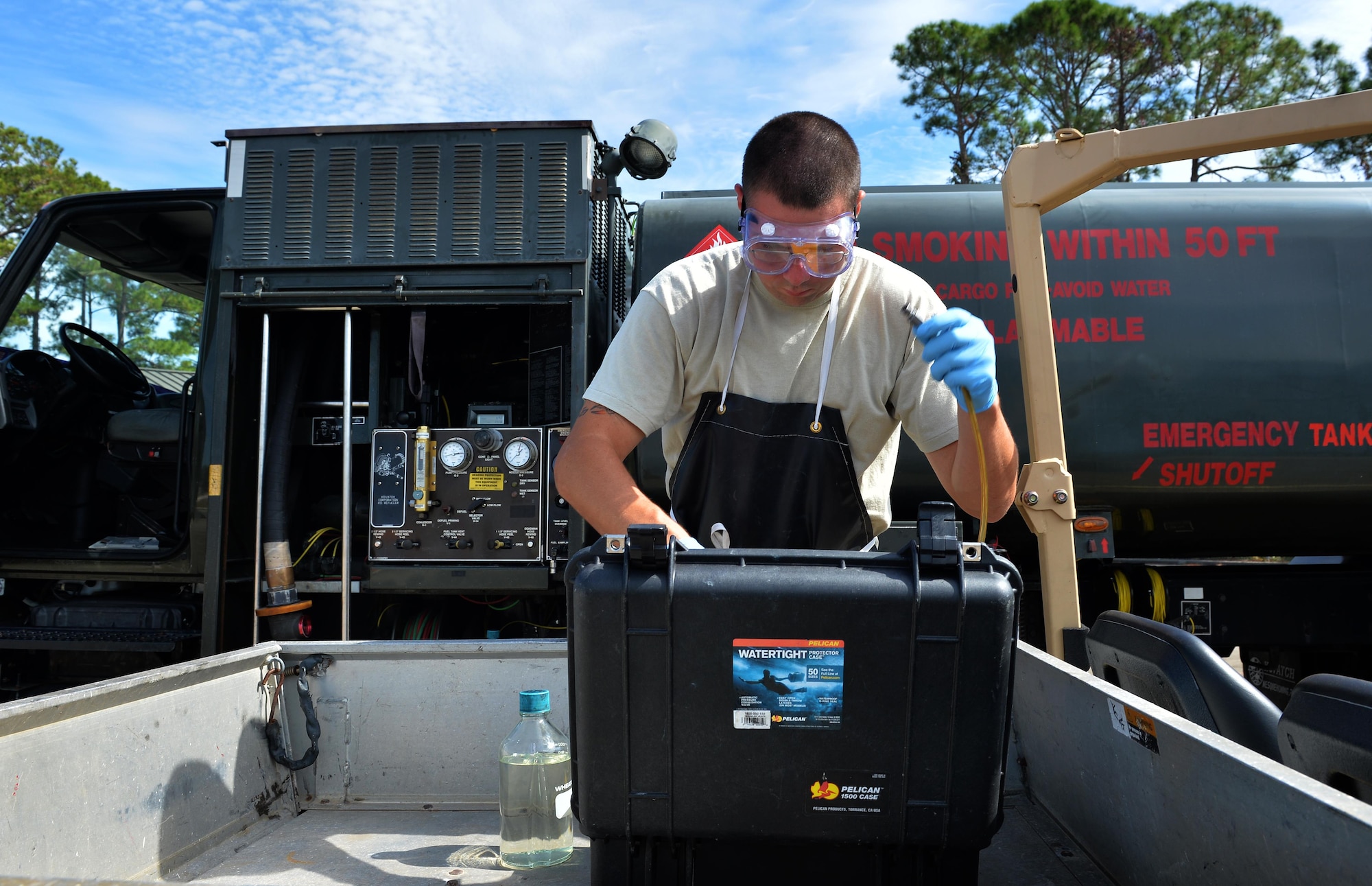 Staff Sgt. Timothy Andrews, NCO in charge of the fuels lab for the 1st Special Operations Logistics Readiness Squadron, collects fuel samples for testing at Hurlburt Field, Fla., Oct. 25, 2016. Fuel specialists test petroleum from fuel trucks monthly to ensure aircraft are provided clean gas. (U.S. Air Force photo by Senior Airman Andrea Posey)