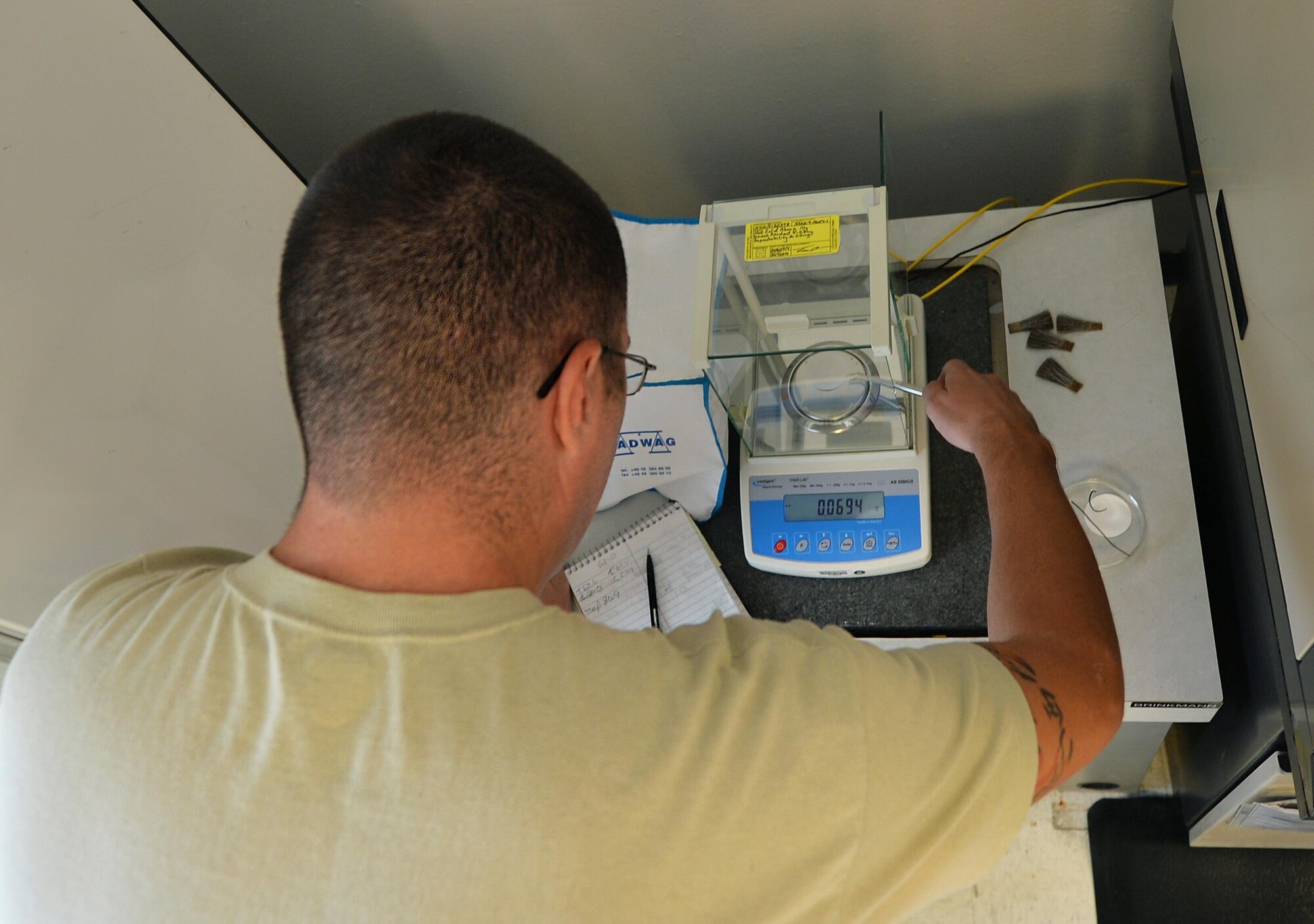 Staff Sgt. Timothy Andrews, NCO in charge of the fuels lab for the 1st Special Operations Logistics Readiness Squadron, weighs membrane filters at Hurlburt Field Fla, Oct. 25, 2016. Membrane filters collect sediment during testing as a limited amount of residue is allowed in petroleum when used in vehicles to keep from damaging engines. (U.S. Air Force photo by Senior Airman Andrea Posey)