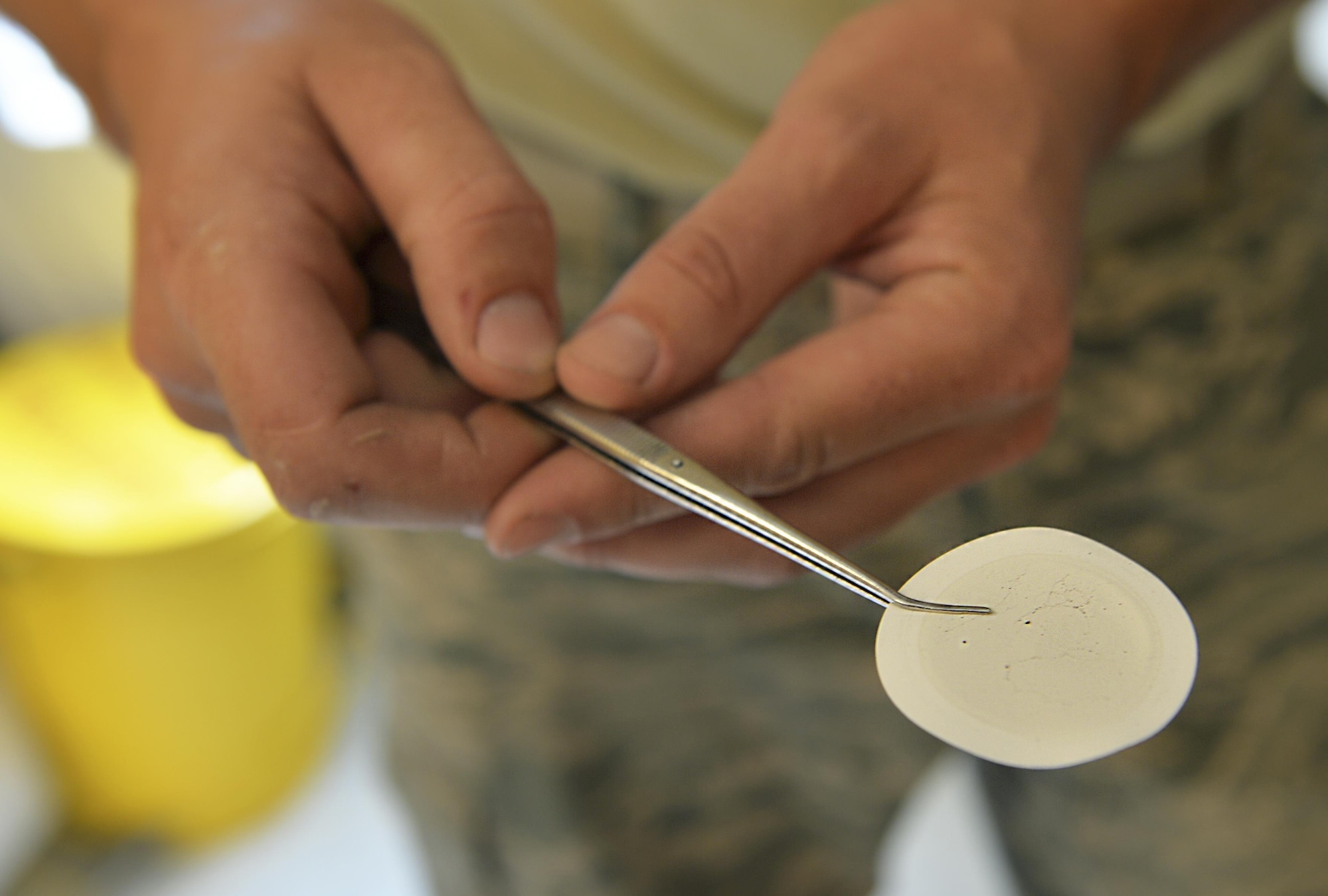 Staff Sgt. Timothy Andrews, NCO in charge of the fuels lab of the 1st Special Operations Logistics Readiness Squadron, checks a membrane filter for sediment at Hurlburt Field Fla, Oct. 25, 2016. Andrew checks the filters for sediment to see what kind and how much residue is found in the fuel. (U.S. Air Force photo by Senior Airman Andrea Posey)