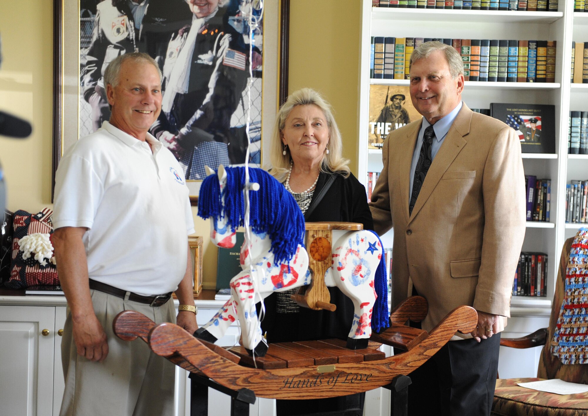 Larry Vetter, 81st Medical Group Keesler Fisher House director; Susan Peterson, Keesler Fisher House Board member, and her husband, retired Lt. Gen. Mike Peterson pose for a photo with a “Patriotic Pony” at the Keesler Fisher House during a dedication ceremony Oct. 24, 2016, on Keesler Air Force Base, Miss. Hero’s Rock, a non-profit organization, dedicated the handmade pony in memory of 1st Lt. Michael Blassie, Jr., who was killed in action in Vietnam May 11, 1972. Since Sept. 1, 2016, Hero’s Rock delivered 18 “Patriotic Ponies” to 12 Fisher House locations; with Keesler being the final stop. The group created each pony in memory of a military member killed in action.  (U.S. Air Force photo by Kemberly Groue/Released) 