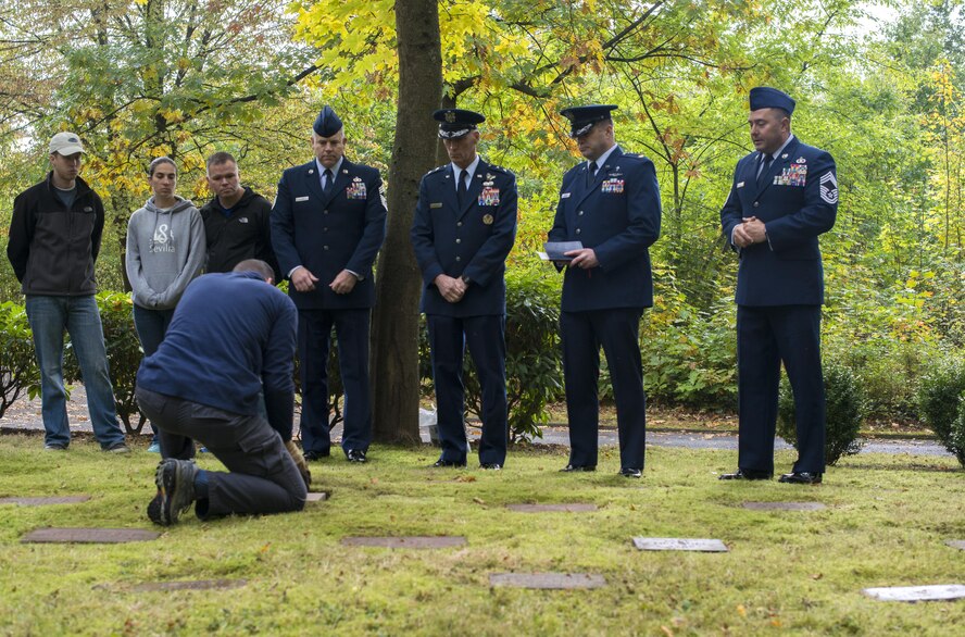 Lt. Col. Jason Shephard, 86th Operations Support Squadron commander, lays a gravestone in place during a dedication ceremony for Gary Currie, an infant who lost his life in 1952, at the American Kindergraves in Kaiserslautern, Germany, Oct. 15, 2016. Joy Caffey, Gary’s mother, does not know where her son is laid to rest. Her family reached out to the Ramstein Area Chiefs’ Group and they offered to dedicate a gravestone to Gary within the Kindergraves. (U.S. Air Force photo by Senior Airman Tryphena Mayhugh)