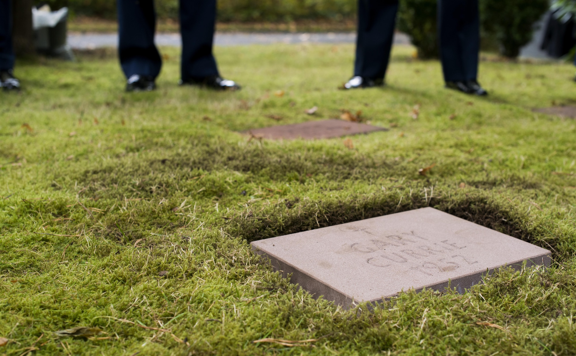 A headstone for Gary Currie, an infant who lost his life in 1952, lays in place during a dedication ceremony at the American Kindergraves in Kaiserslautern, Germany, Oct. 15, 2016. Joy Caffey, Gary’s mother, does not know where her son is laid to rest. Her family reached out to the Ramstein Area Chiefs’ Group and they offered to dedicate a gravestone to Gary within the Kindergraves.  (U.S. Air Force photo by Senior Airman Tryphena Mayhugh)