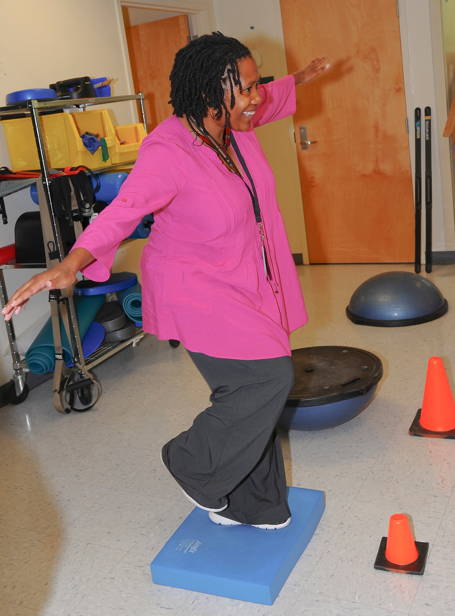 Lachaune Alexander, 78 Medical Group dental secretary, tries her balance during the Physical Therapy open house, Oct 26, 2016.To observe the National Physical Therapy month, 78th Med Group hosted an event with games to introduce their equipment. (U.S. Air Force photo by Misuzu Allen)