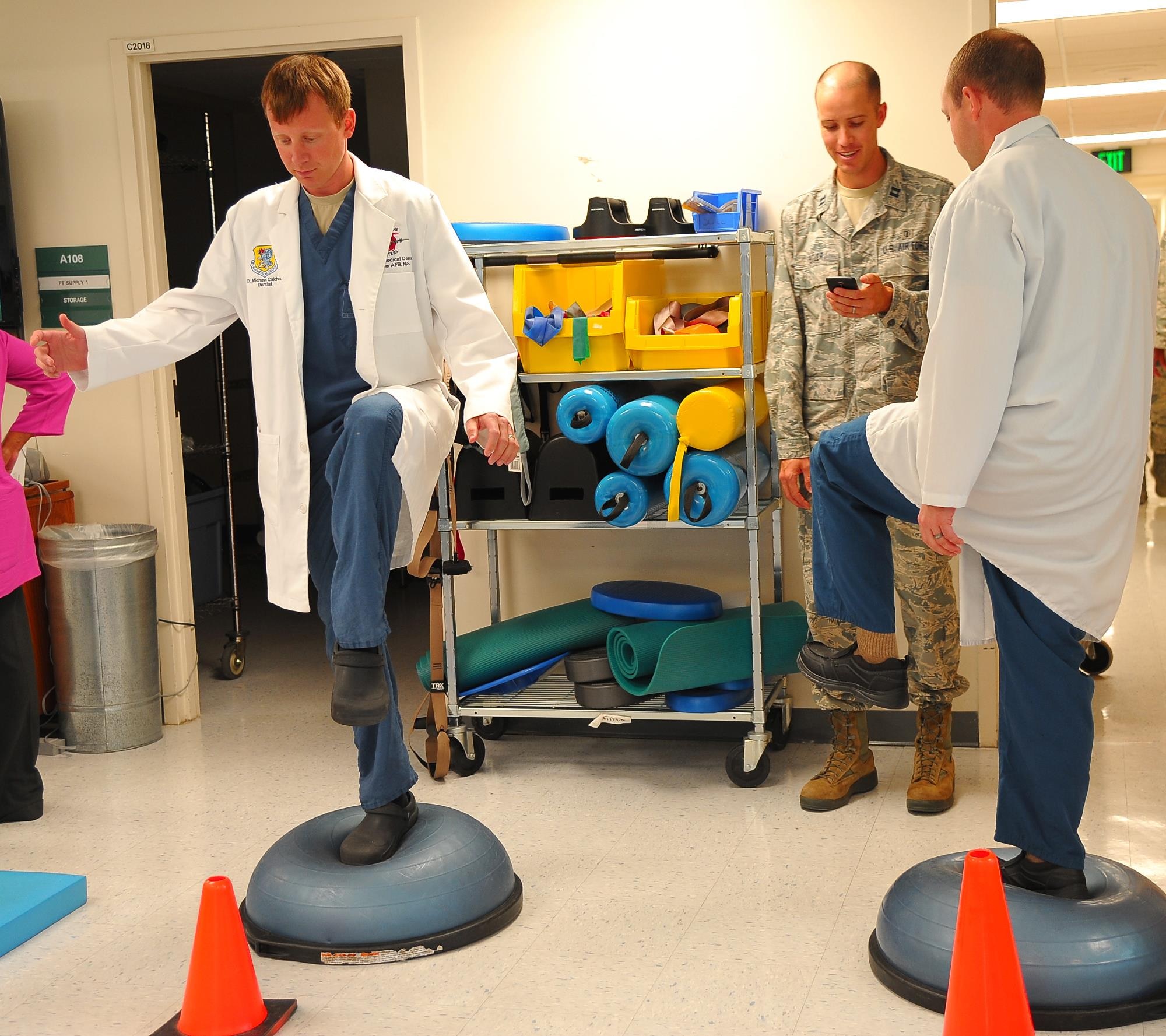 Captains Kyle Caldwell and Richard Waddell, both the 78th Medical Group dentists, stand on the balance trainer ball competition during the Physical Therapy open house, Oct 26, 2016. To obser the National Physical Therapy month, 78th Med Group hosted an open house on the second floor of the Medical Group facility. (U.S. Air Force photo by Misuzu Allen)