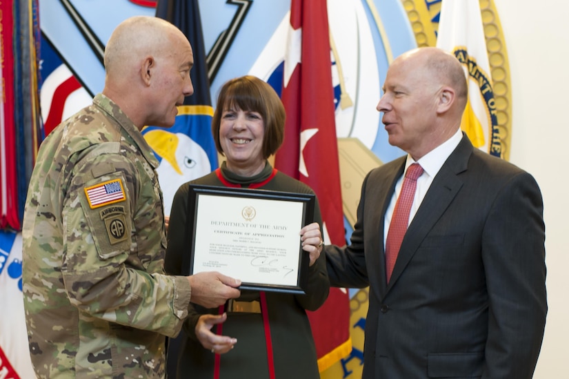 LTG Charles D. Luckey, left, Commanding General, U.S. Army Reserve Command, presents a certificate of appreciation to Marie Balocki, wife of James Balocki, U.S. Army Reserve chief executive officer, at the USARC headquarters, during Balocki's farewell ceremony, Oct. 26, 2016, at Fort Bragg, N.C. Balocki says goodbye to the Army after a combined 35 years of uniformed and civilian service to take a Senior Executive Service position with the Department of the Navy. (U.S. Army photo by Timothy L. Hale)(Released)