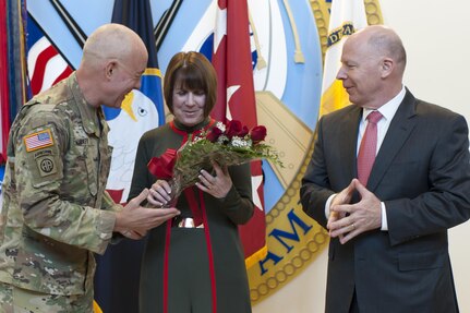 LTG Charles D. Luckey, left, Commanding General, U.S. Army Reserve Command, presents roses to Marie Balocki, wife of James Balocki, U.S. Army Reserve chief executive officer, at the USARC headquarters, during Balocki's farewell ceremony, Oct. 26, 2016, at Fort Bragg, N.C. Balocki says goodbye to the Army after a combined 35 years of uniformed and civilian service to take a Senior Executive Service position with the Department of the Navy. (U.S. Army photo by Timothy L. Hale)(Released)