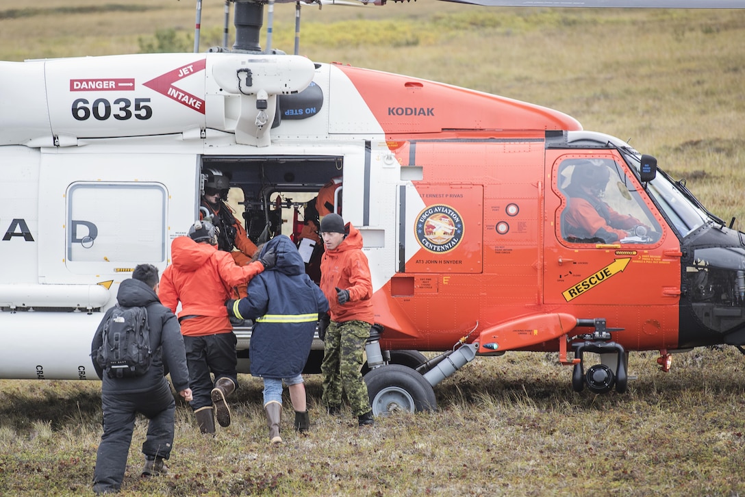 Alaska Air National Guard and Royal Canadian Air Force search and rescue personnel load simulated casualties onto an MH-60 Jayhawk helicopter from U.S. Coast Guard Air Station Kodiak during exercise Arctic Chinook, near Kotzebue, Alaska. Arctic Chinook is a joint U.S. Coast Guard and U.S. Northern Command sponsored exercise which focuses on multinational search and rescue readiness to respond to a mass rescue operation requirement in the Arctic. (U.S. Air National Guard photo by Staff Sgt, Edward Eagerton)