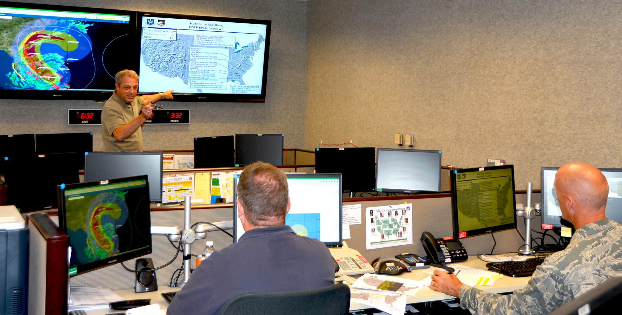 Rick Bacon, 1st Air Force (Air Forces Northern) National Security Preparedness Regional Director, FEMA Region VI, discusses the direction of Hurricane Matthew and the deployment of emergency preparedness liaison officers (EPLOS) with Rich Davis, 601 Air Operations Center, Defense Support of Civil Authorities Liaison, and Lt. Col. Tyler Moore, 1st Air Force (Air Forces Northern) National Security Preparedness Regional Director, FEMA Region II. Hurricane Matthew began its path up the eastern coast from southern Florida Thursday evening. (USAF Photo by Maj Katrina Andrews)