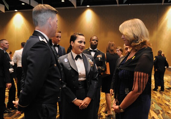 Tech Sgt. Cassandra Cruz, 81st Force Support Squadron Airman Leadership School instructor, speaks with Col. C. Mike Smith, 81st Training Wing vice commander, and Air Force Secretary Deborah Lee James during the 38th Annual Salute to the Military at the Mississippi Coast Convention Center, Oct. 25, 2016, Biloxi, Miss. James was the guest speaker at the event, which recognized the men and women who serve in the military along the Gulf Coast. Cruz was highlighted during the event for being selected as one of the 12 Air Force Outstanding Airmen of the Year. (U.S. Air Force photo by Kemberly Groue/Released)